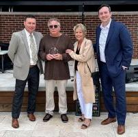 Lynn Richardet receives his award from Saint Francis Foundation Board President Garrett Ozbun, Robin Sims, and Saint Francis Foundation Executive Director Stacy Huff.